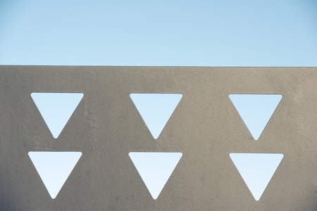 Close-up of a metal surface with triangles cut out.の写真素材
