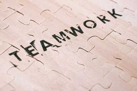 Teamwork word stamped on a wooden puzzle.の写真素材