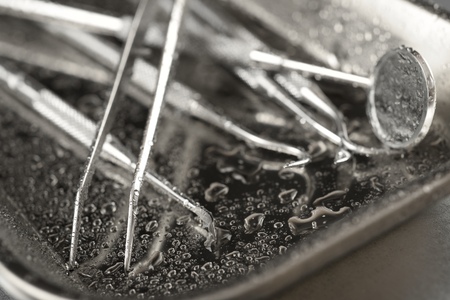 Instruments used by the dentist on a metal tray.