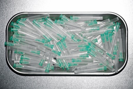 Group of needles for syringe on a metal tray.の写真素材