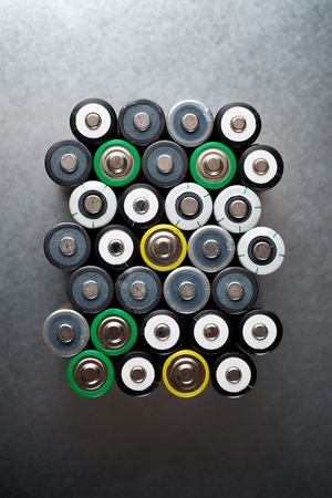 Many batteries on a metal table.の写真素材
