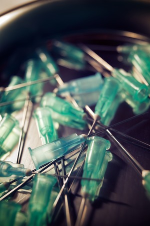 Group of needles for syringe on a metal tray.の写真素材