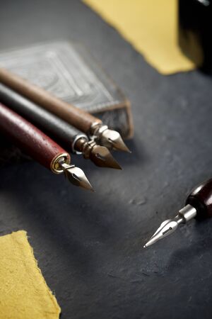 Nib pens for calligraphy on a old book.の写真素材