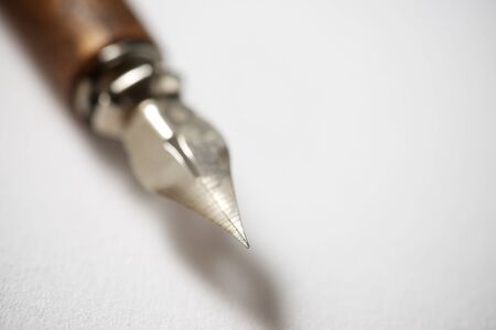 Nib pen for calligraphy on a white paper.の写真素材