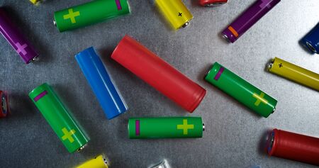Many batteries on a metal table.の写真素材