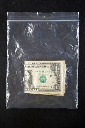 Dollar bills in a plastic bag.