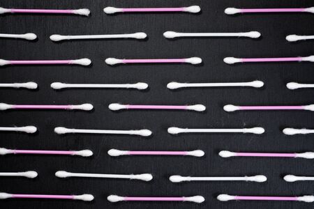 Ear swabs on a black table.の写真素材