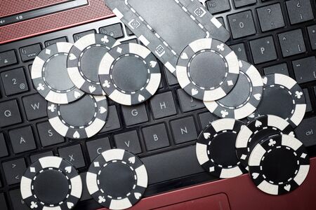 Casino chips stacking on a laptop.の写真素材