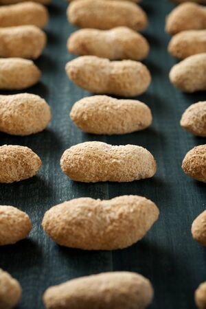 Peanuts with shell on a table.