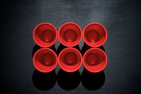 Drinking plastic cups on a black table.の写真素材