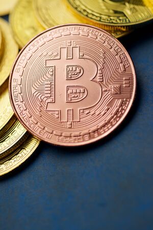 Bitcoins on a blue table.