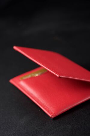 Leather wallet on a black table.
