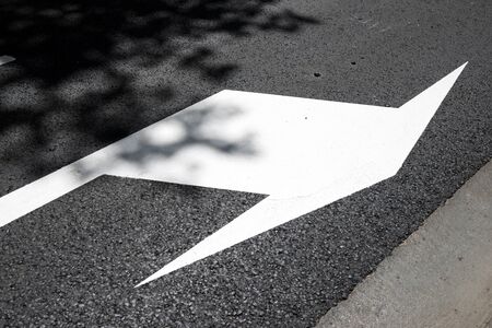 Single arrow directional sign on the floor.