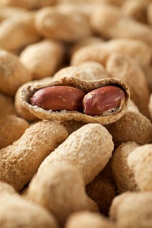 Peanuts with shell on a table.
