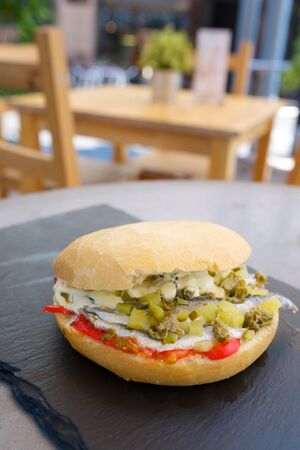 Anchovies sandwich with pepper and gherkins.の写真素材