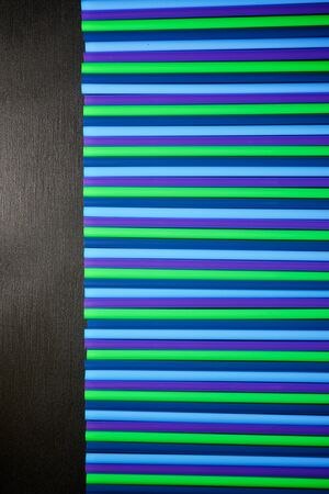 Drinking plastic straws on a black table.の写真素材