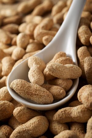 Peanuts with shell on a table.