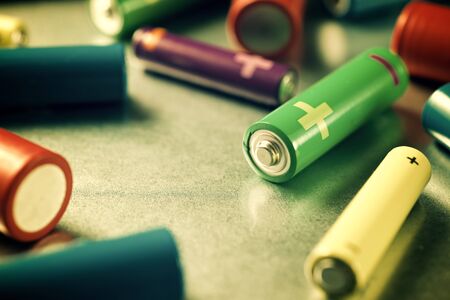 Many batteries on a metal table.の写真素材