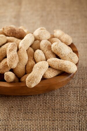 Peanuts with shell on a table.