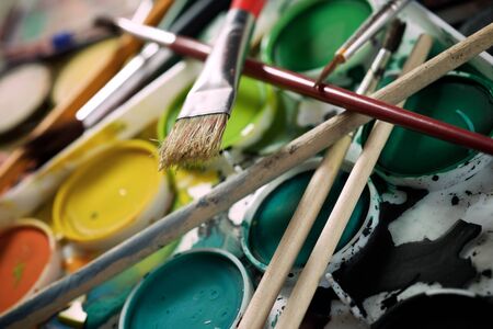 Box of watercolors and brushes on a table.の写真素材