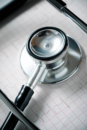 Close up of an electrocardiogram in paper form and a stethoscope.の写真素材
