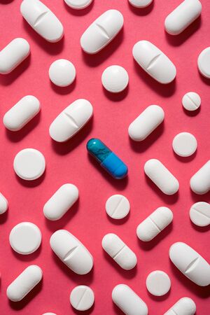 Pills on a pink table.の写真素材