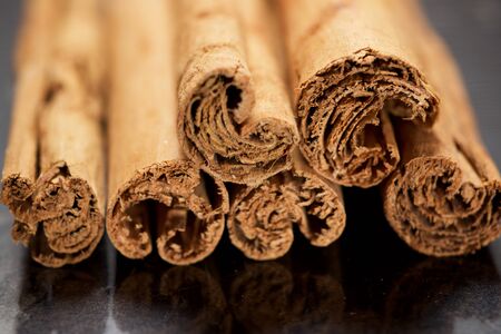 Cinnamon sticks on a marble table.