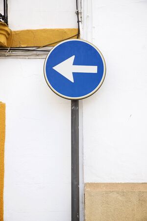 Mandatory direction signal for vehicles in a street in Cordoba, Andalucia, Spain.