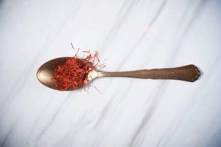 Saffron in a small metallic spoon.の写真素材
