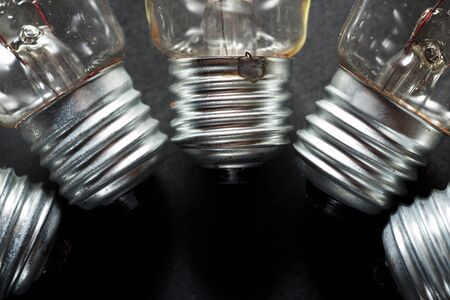 An old incandescent bulbs on a black table.の写真素材