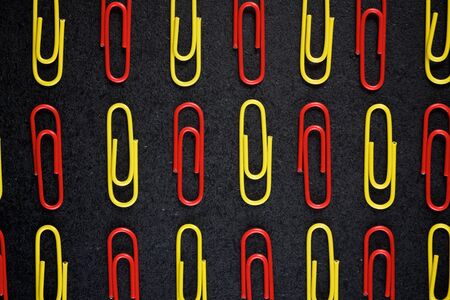 Paperclips group on a black table.の写真素材