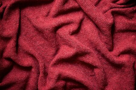 Close up of a garnet colored fabric.