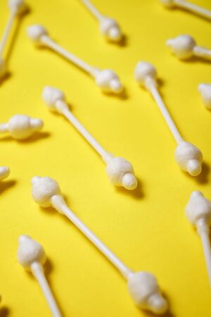 Ear swabs on a yellow table.の写真素材