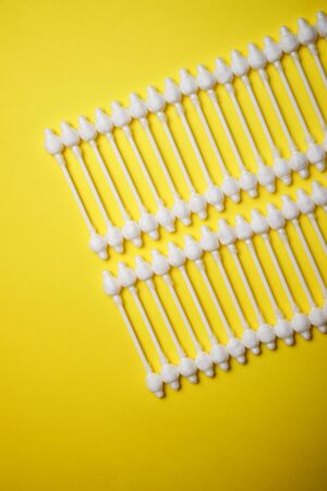 Ear swabs on a yellow table.の写真素材