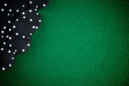 Casino chips stacking on a green felt.の写真素材
