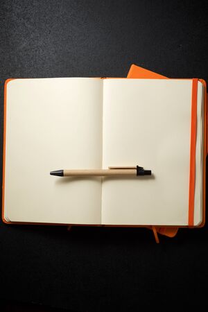 Notebooks view on a black table.