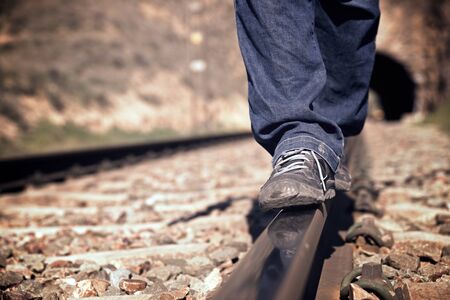 Young man doing balances on a train track, Zaragoza Province, Aragon in Spain.