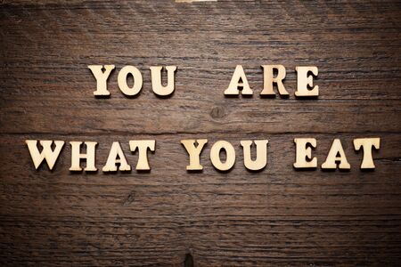 You are what you eat sentence on a wood table.の写真素材