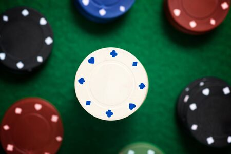 Casino chips stacking on a green felt.の写真素材