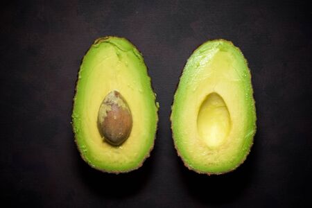Avocado on a brown table.の写真素材