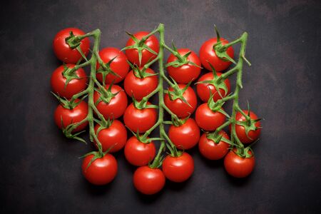 Cherry tomatoes on a black table.の写真素材