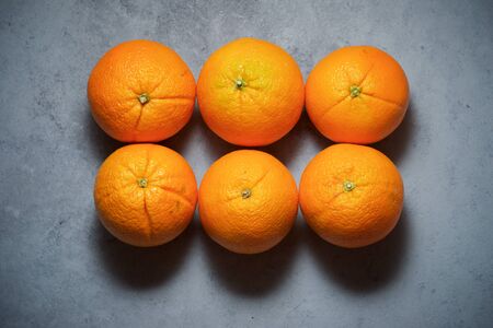 Oranges on a gray table.の写真素材