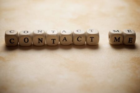 Contact me text on a ochre paper.