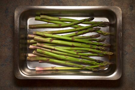 Wild asparagus on a metal tray.の写真素材