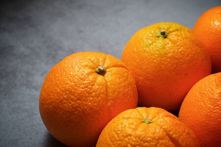 Oranges on a gray table.