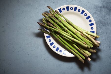 Wild asparagus on a gray table.の写真素材