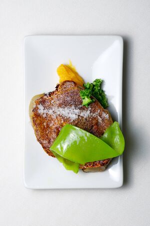 Beef steak with pumpkin in a white plate.の写真素材