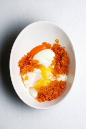 Poached egg in a white bowl.の写真素材