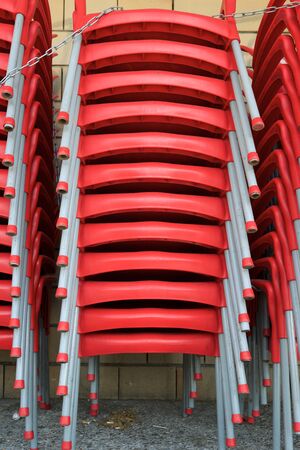 Metal chairs stacked in the street in Zaragoza, Spain.の写真素材