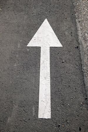 Single arrow directional sign on the floor.